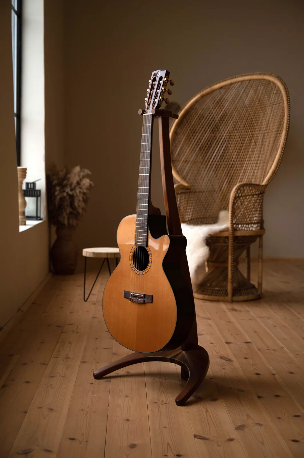 FormaStand One displaying an acoustic guitar in a warm, light interior